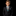 Young boy in a black suit with a colorful tie and pocket square on a black background