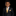 Young boy in a black suit with a yellow tie and pocket square on a black background