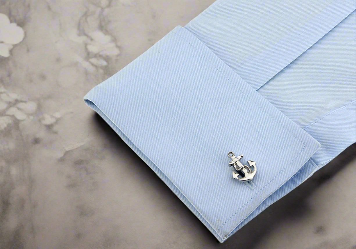 On Sleeve: A chrome colored boat anchor shaped cuff-link