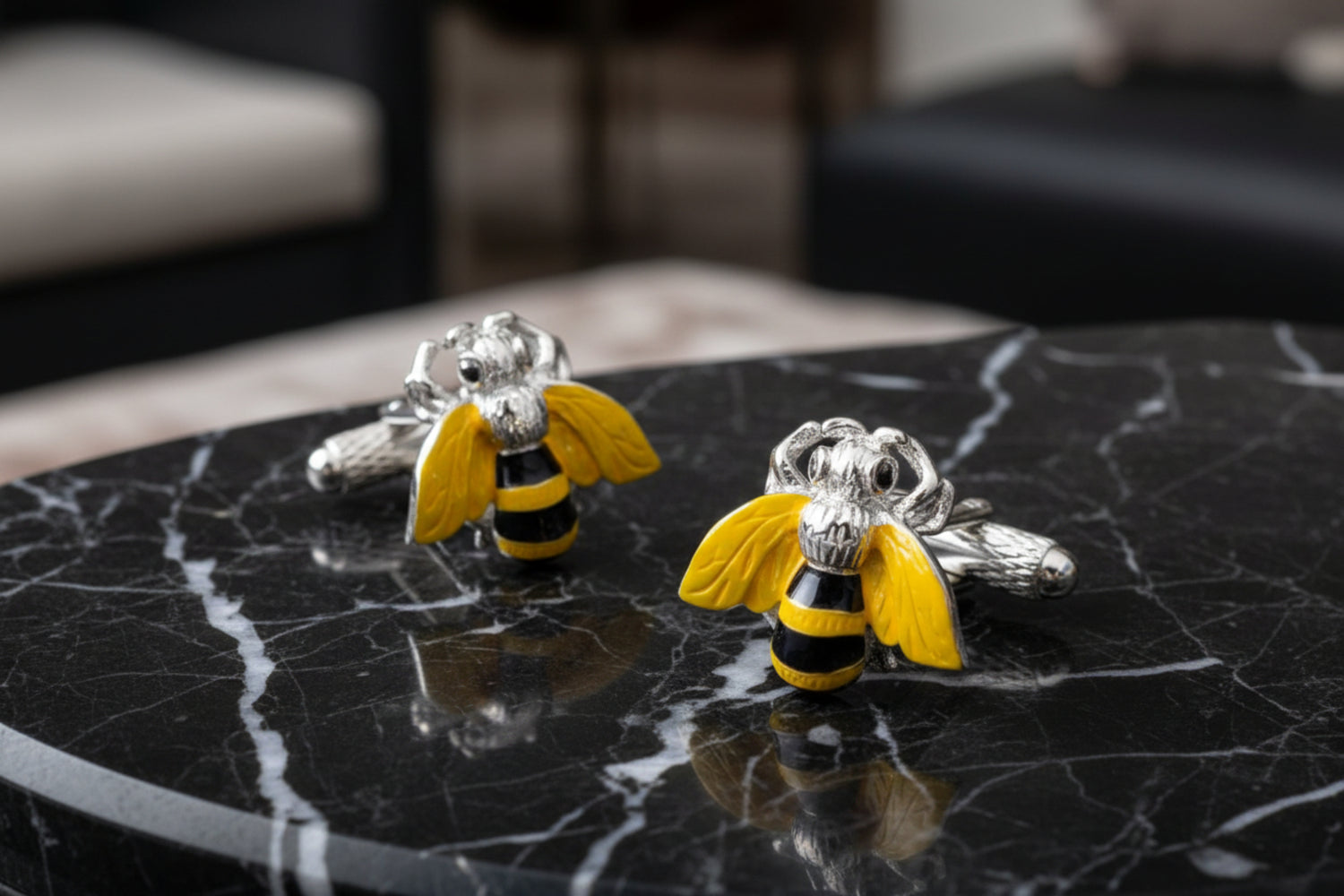 A yellow, black chrome color bee design pair of cuff-links