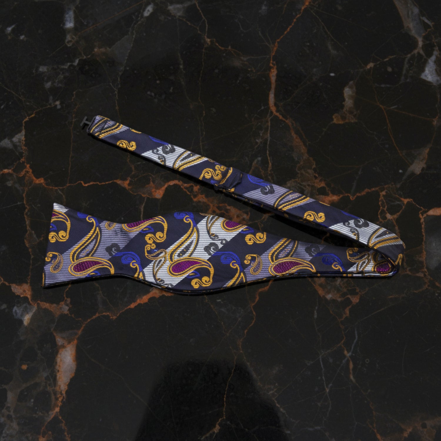 A Black, Orange, Grey Paisley Pattern Self Tie Bow Tie Untied