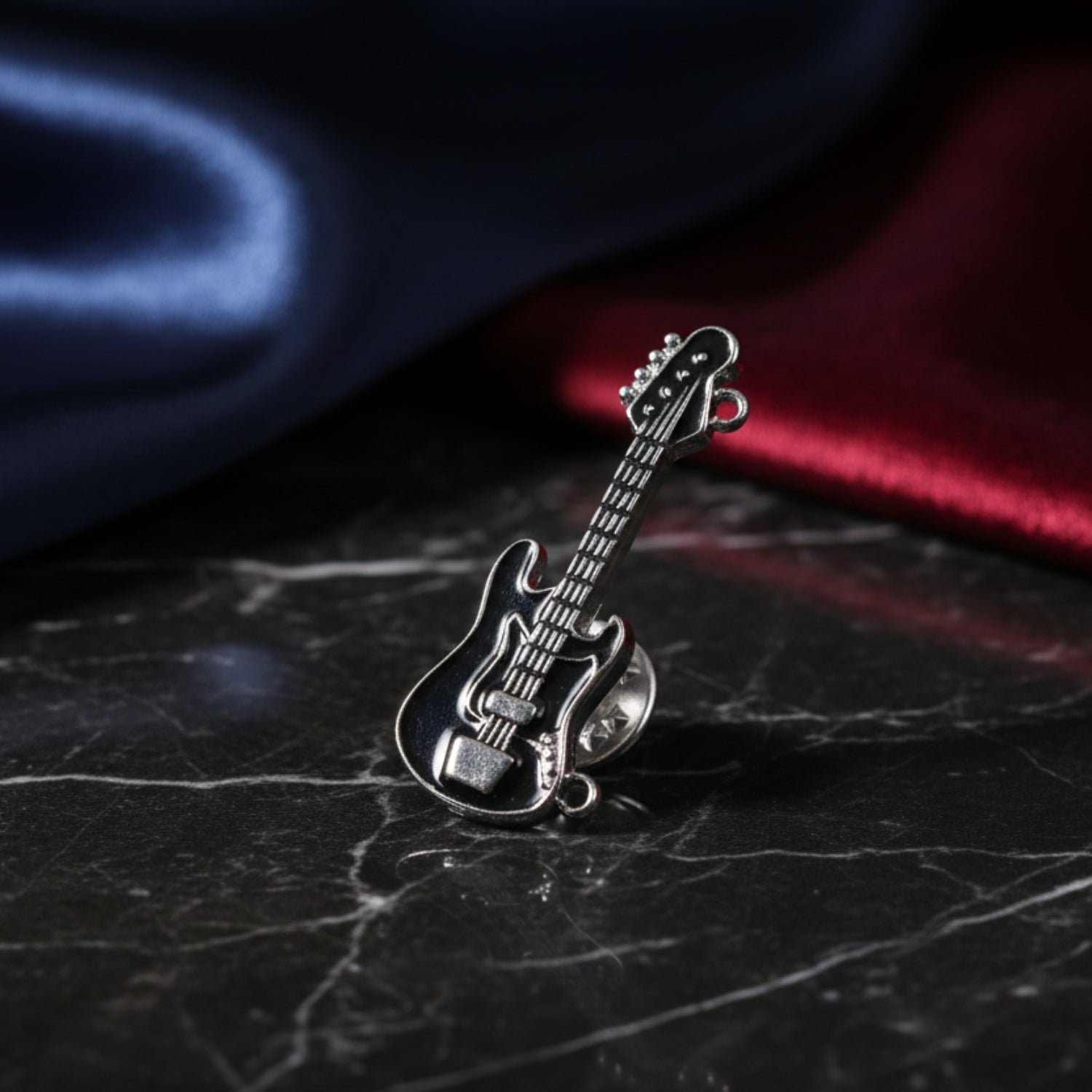 A Black and Chrome Guitar Lapel Pin