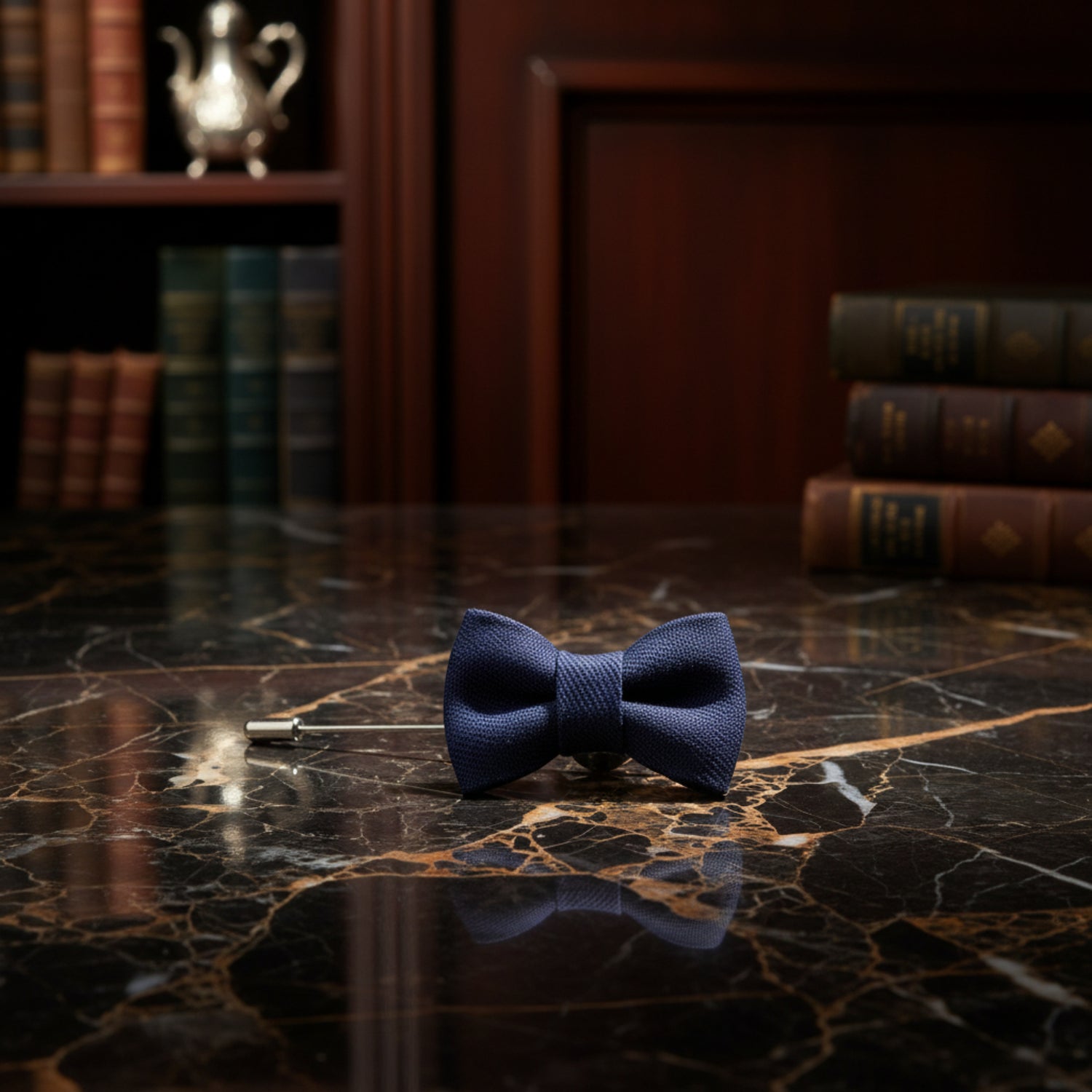 A Blue Colored Bow Tie Shaped Lapel Pin||Deep Blue