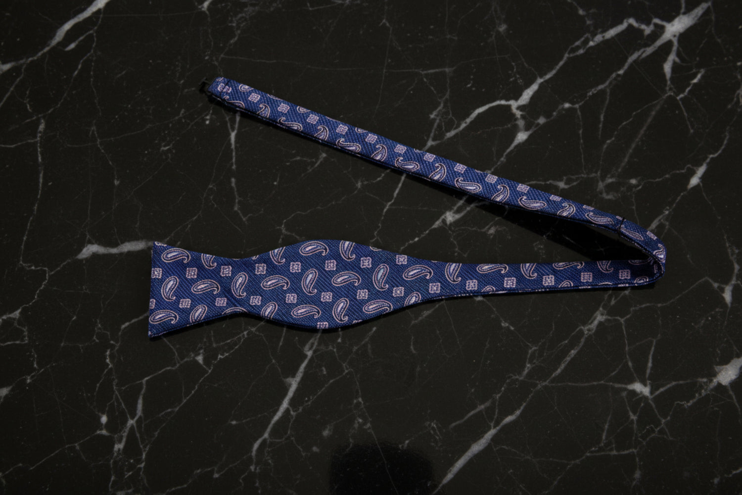 A Deep Blue, Pink Paisley Pattern Self Tie Bow Tie Untied