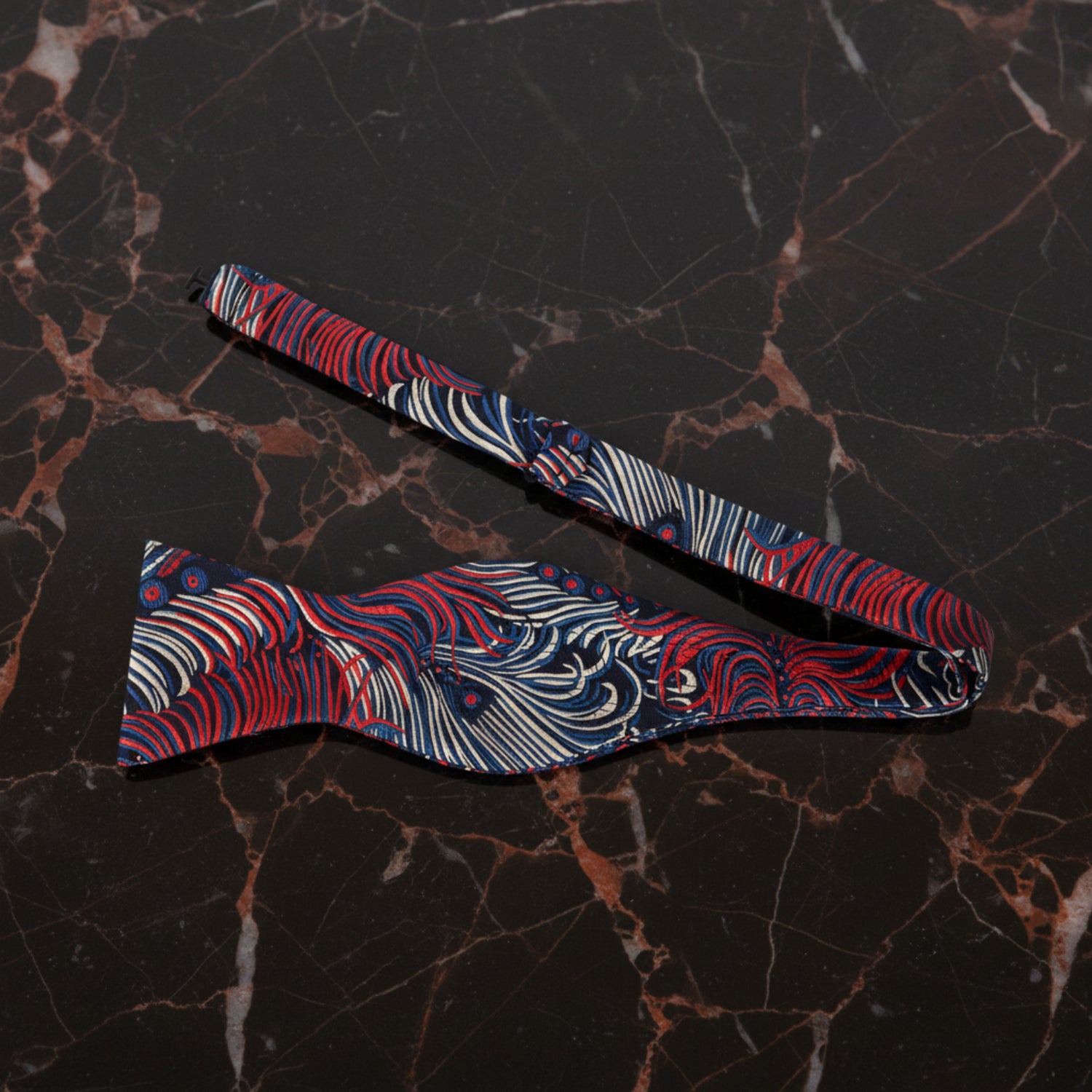 A Blue, Red, Cream Abstract Peacock Pattern Self Tie Bow Tie Untied