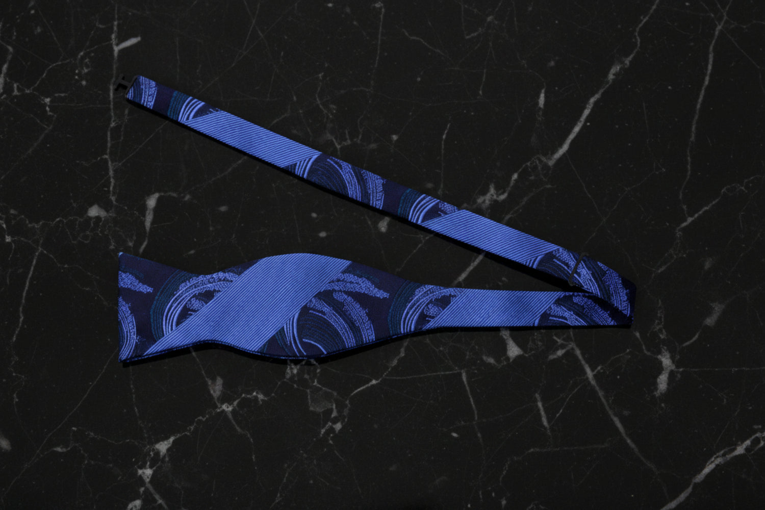A Blue Abstract Swirl with Thick Stripe Pattern Self Tie Bow Tie Untied