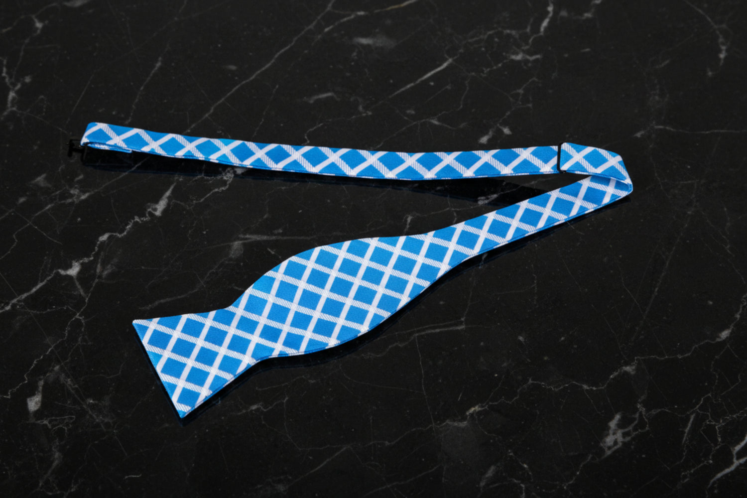 A Light Blue, White Geometric Diamonds Pattern Self Tie Bow Tie Untied View