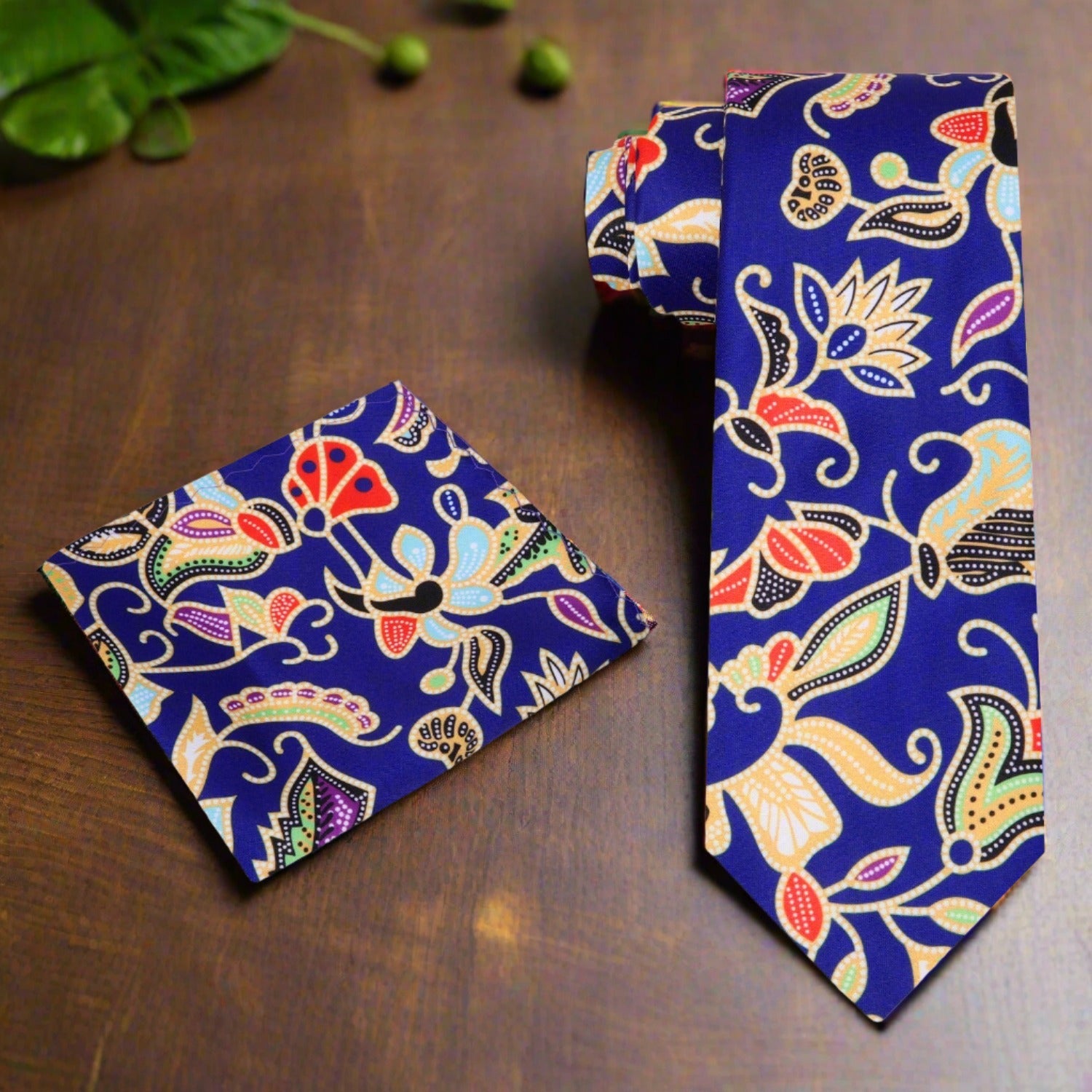 View 2: A Dark Blue, Yellow, Red, And Green Abstract Floral Pattern Necktie, Matching Pocket Square