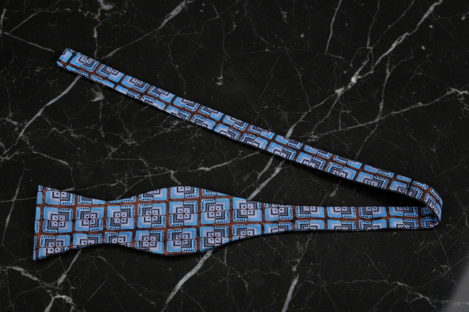 A Blue, Brown Geometric Floral Pattern Bow tie Untied