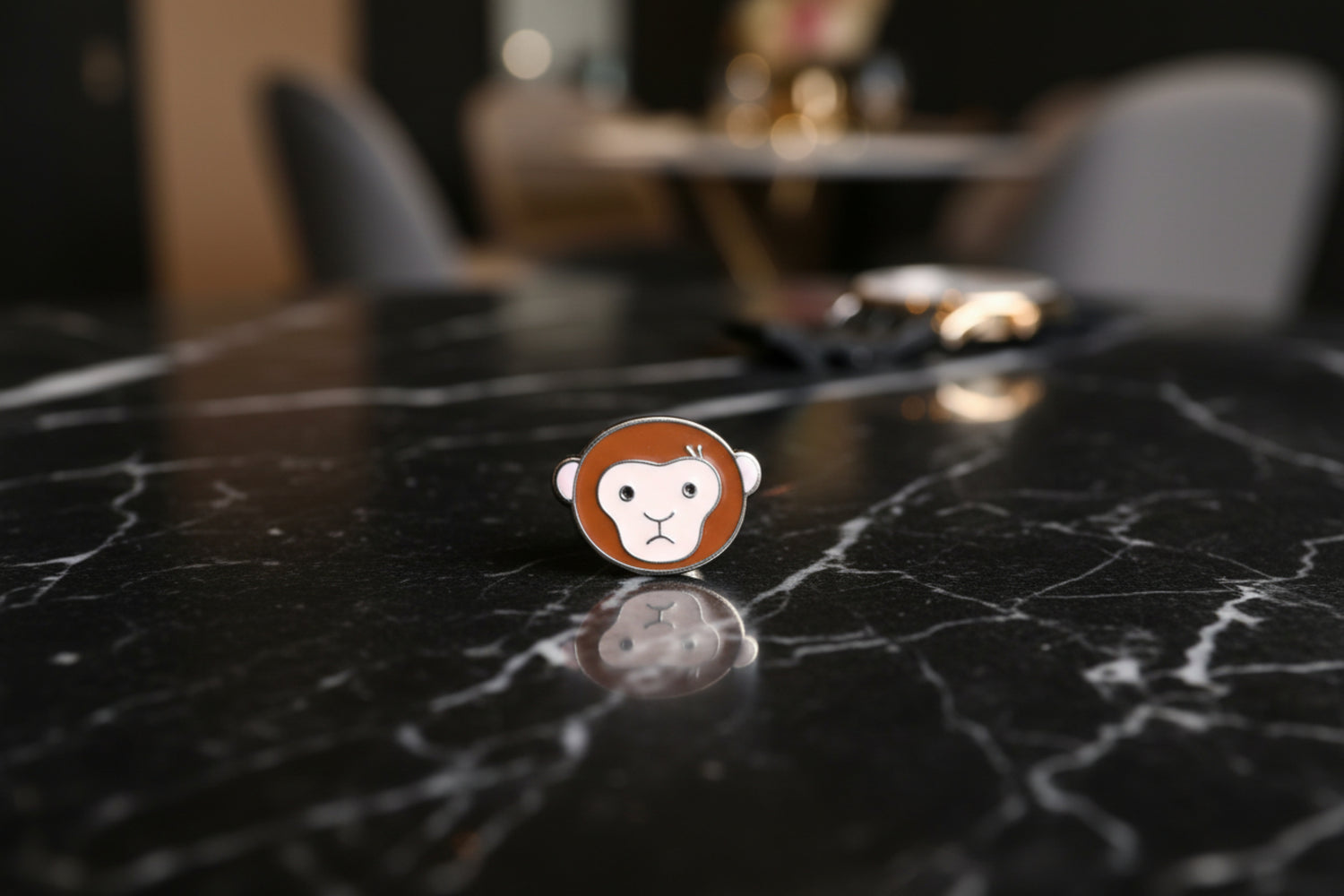 A Brown Monkey Shaped Lapel Pin.||Small Cartoon Monkey
