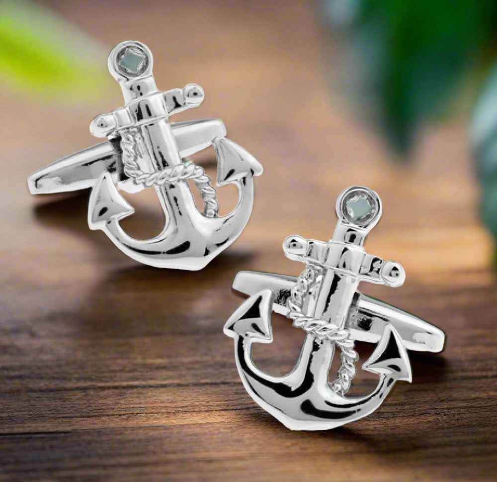 A chrome colored boat anchor shaped cuff-links