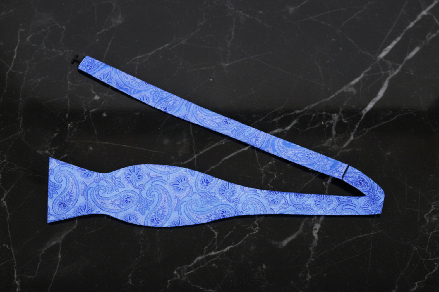 A Light Blue Paisley Pattern Self Tie Bow Tie Untied