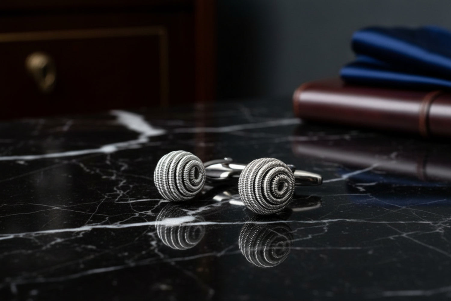 A silver sphere shaped cuff-links||Sphere