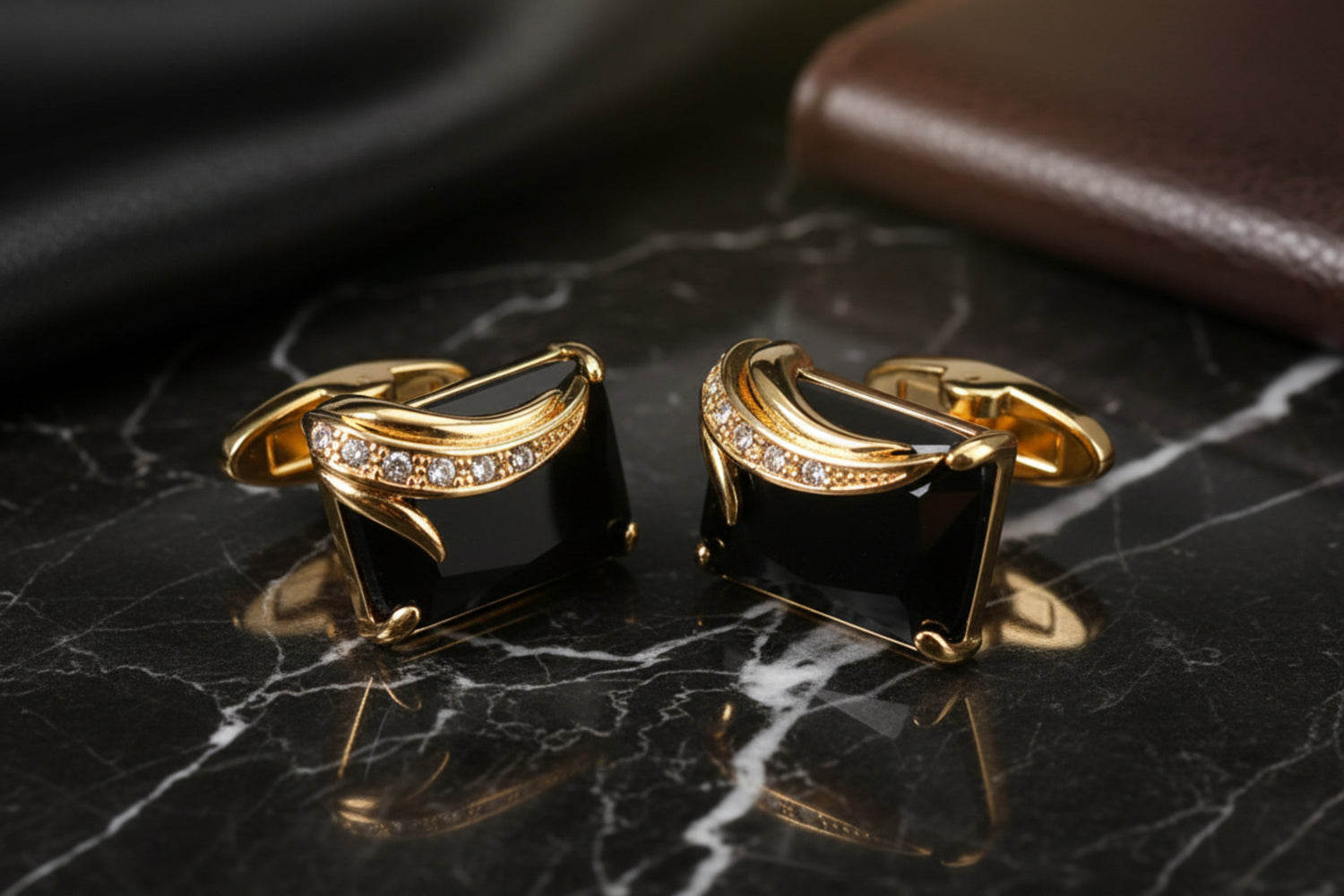 A Gold Colored with Black Gemstones Cuff-links.