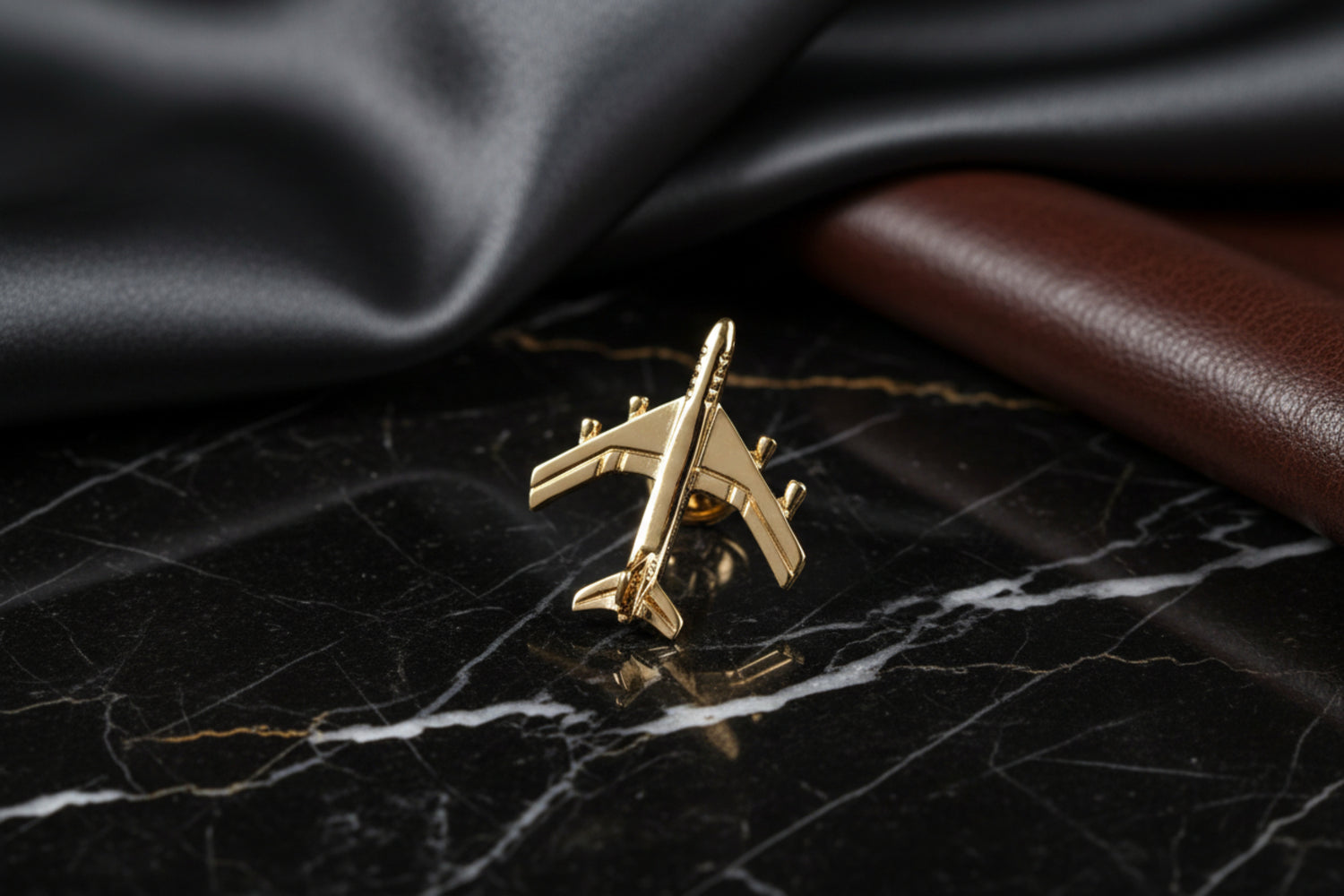 A Gold Airplane Shaped Lapel Pin||Gold