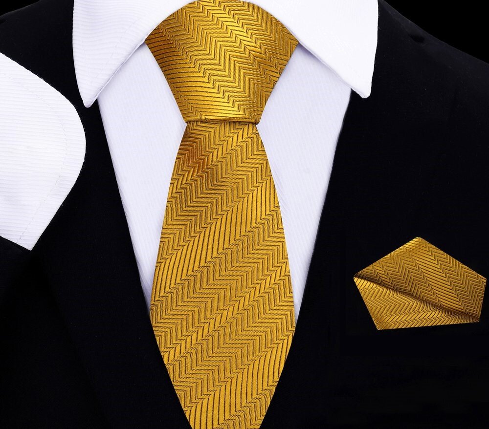 A set of golden amber necktie and pocket square for kids, displayed on a mannequin wearing a black suit and white shirt.