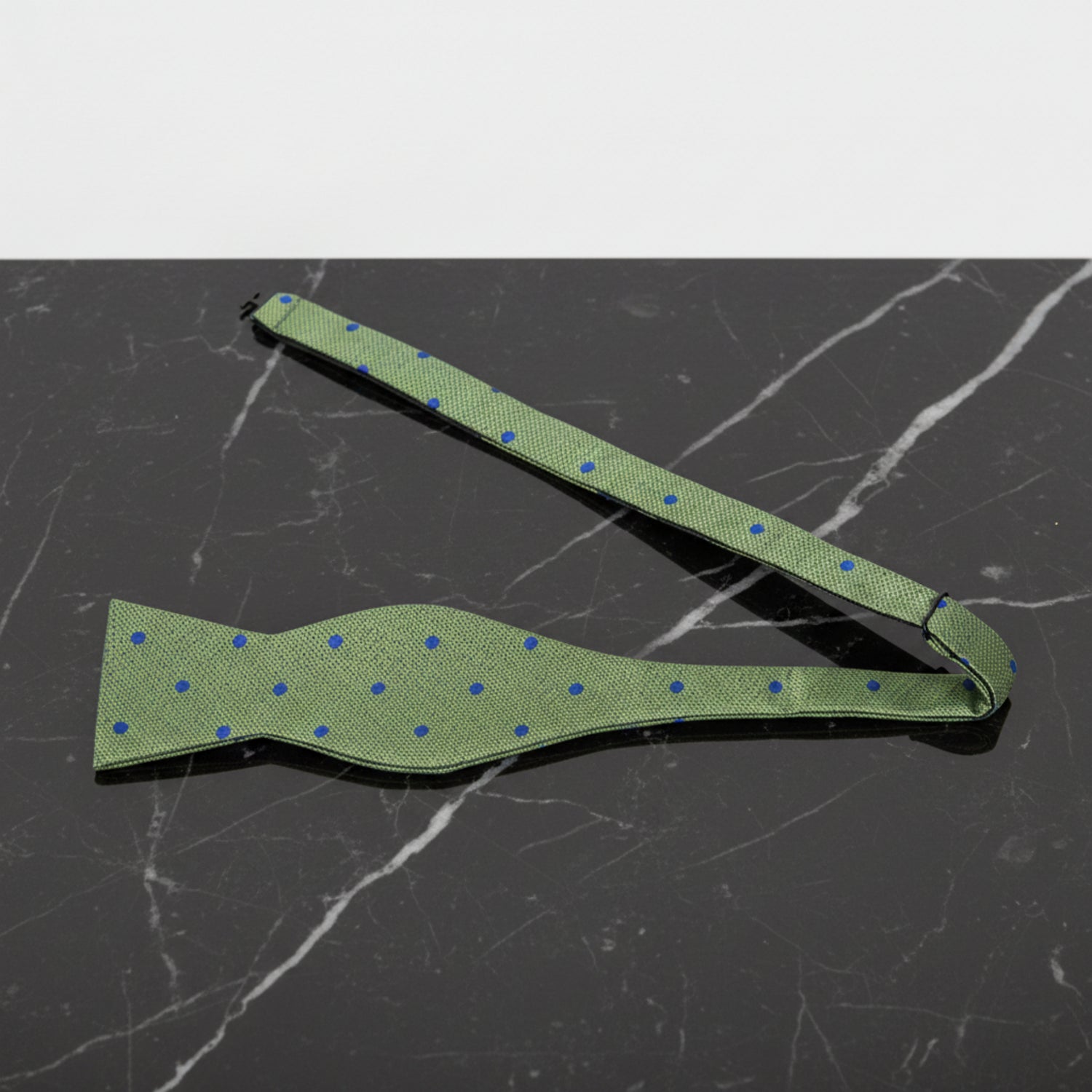 A Green, Blue Polka Dot Pattern Self Tie Bow Tie Untied