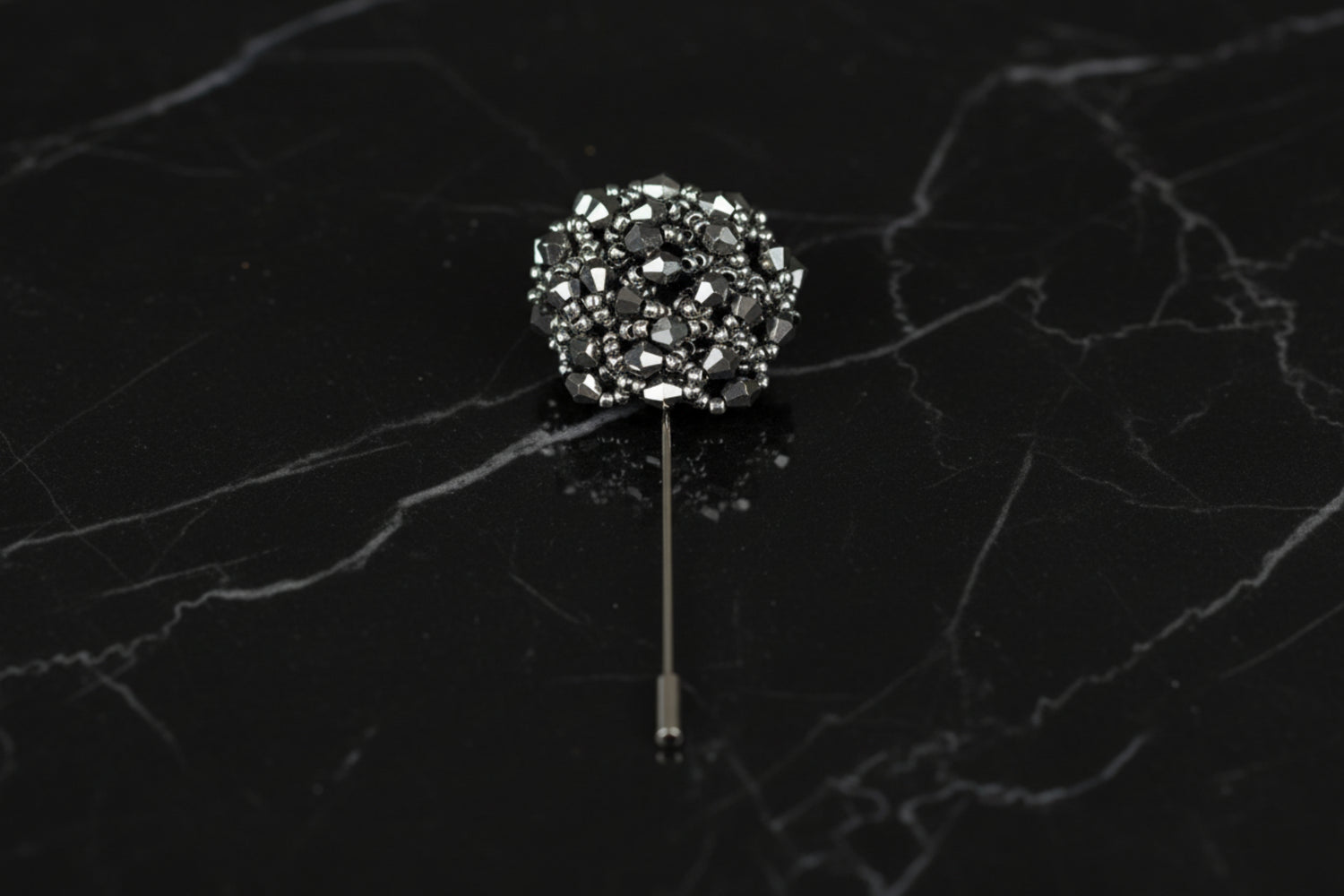A Silver Colored Stone Lapel Cushion||Silver
