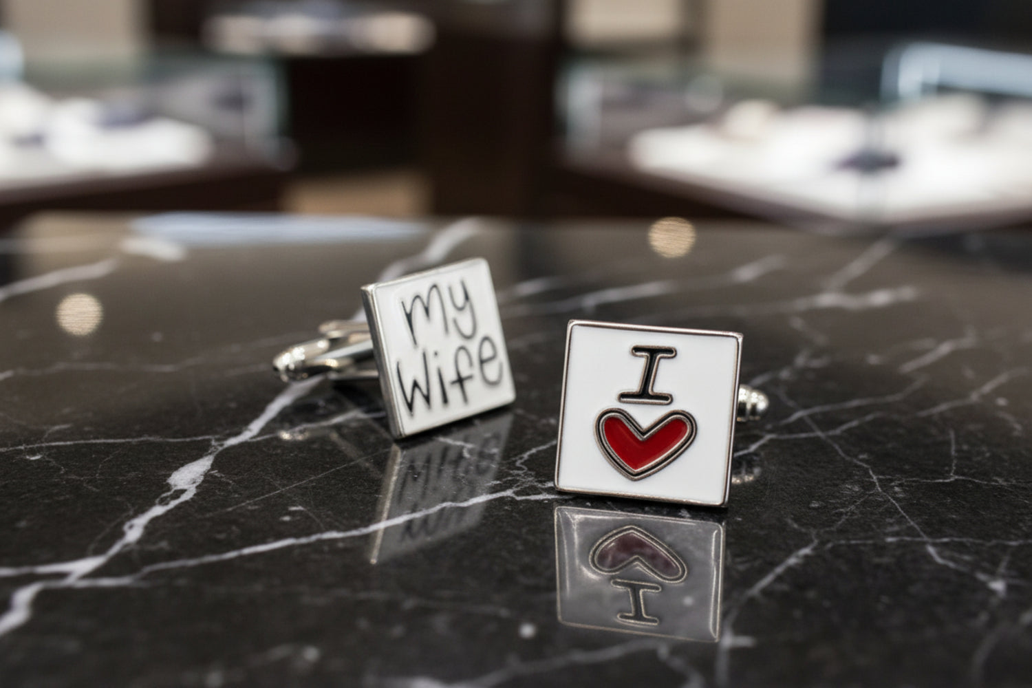 A rectangle shape red, black, white colored with writing "I heart shape my wife" cuff-links.
