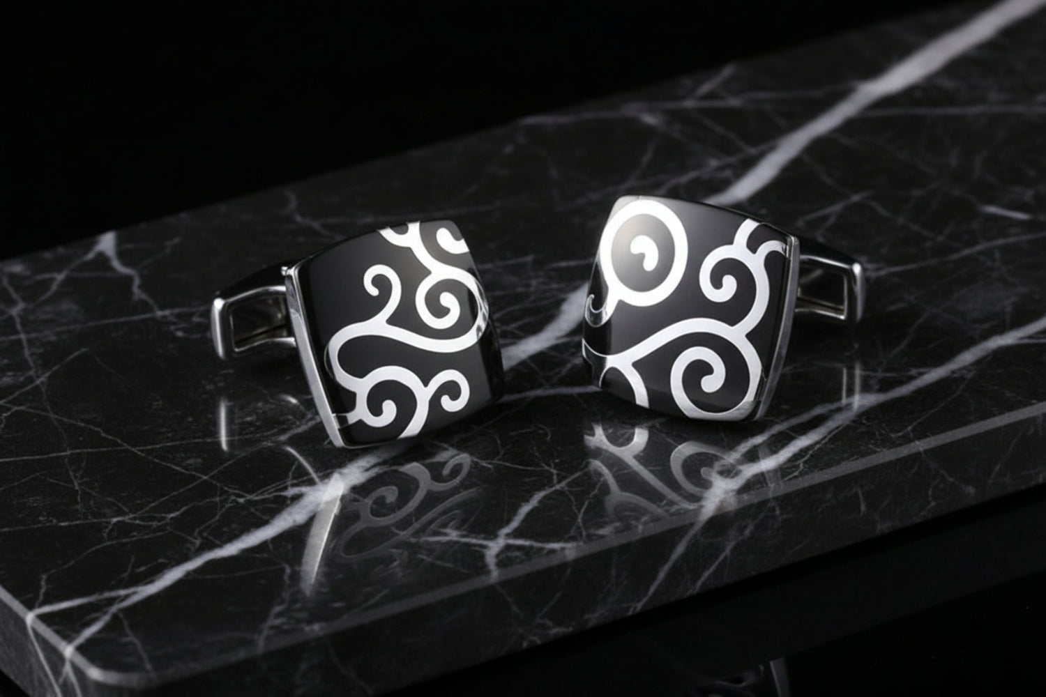 A Black, Chrome Colored Square Shaped With Vine Pattern Cuff-links.