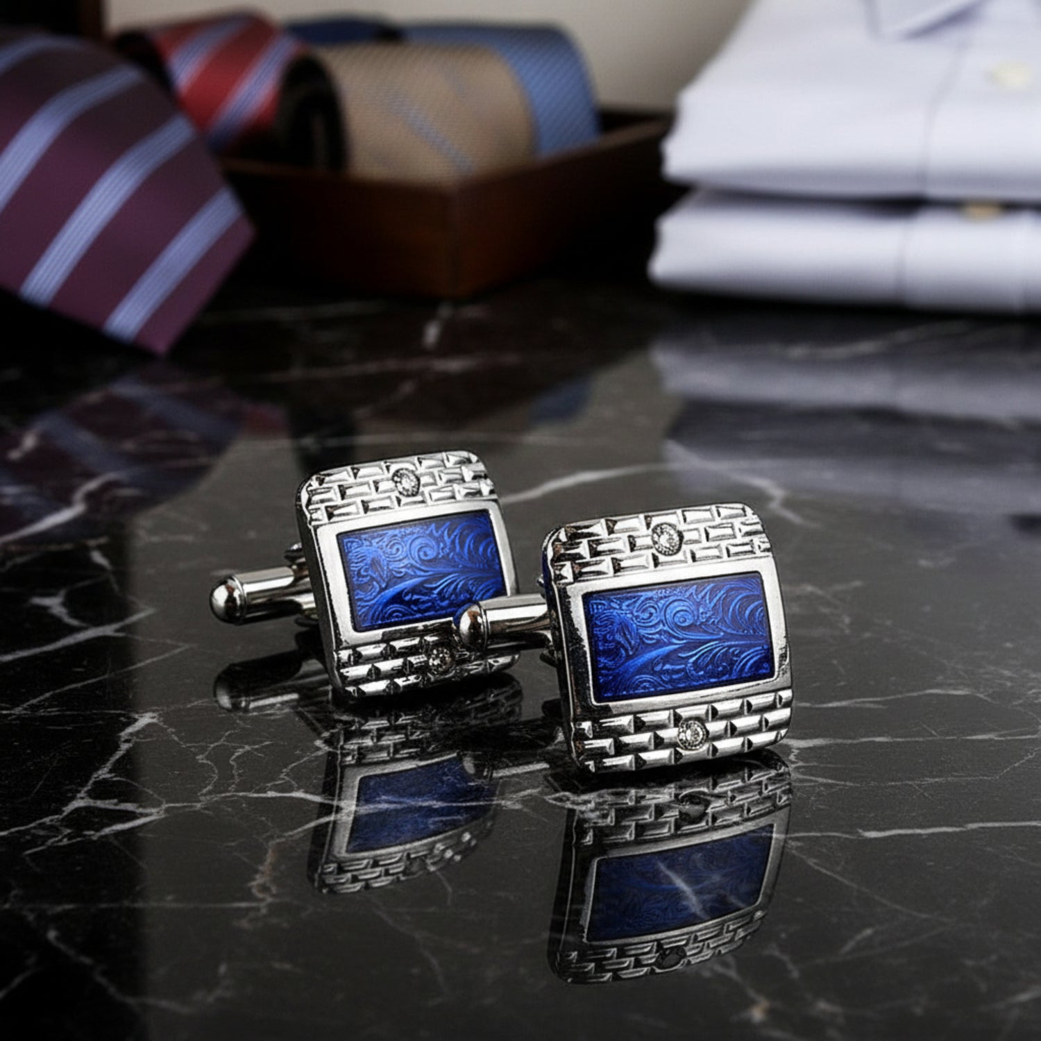View 2: A chrome and blue colored rectangle shaped with checkerboard and waves detail pair of cuff-links