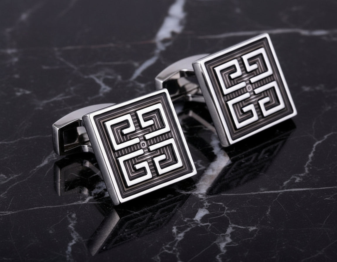 View 3: A Black, Chrome Colored Square Shape With Intricate Design Cuff-links.