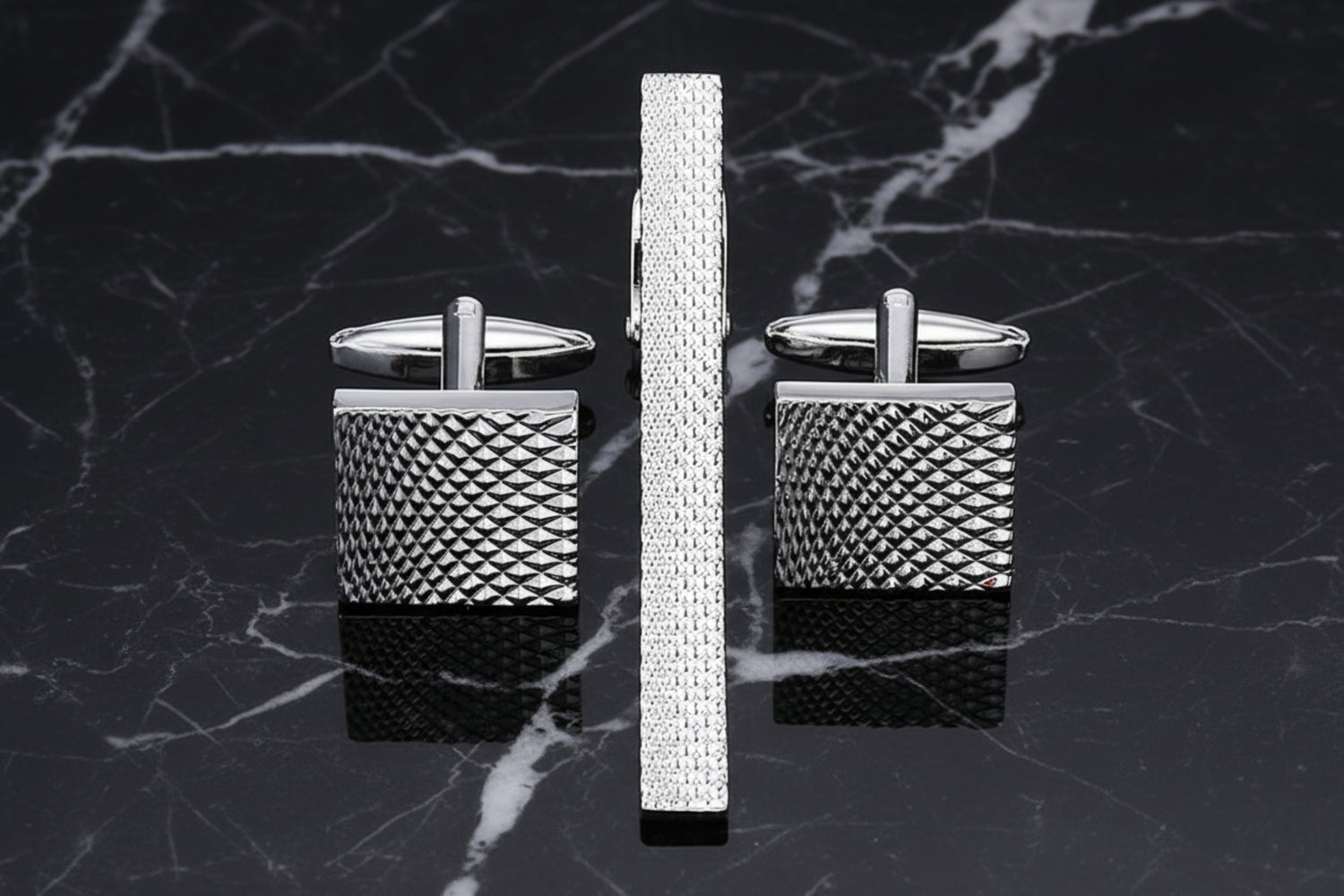 A silver textured tie bar and cuff-links||Silver