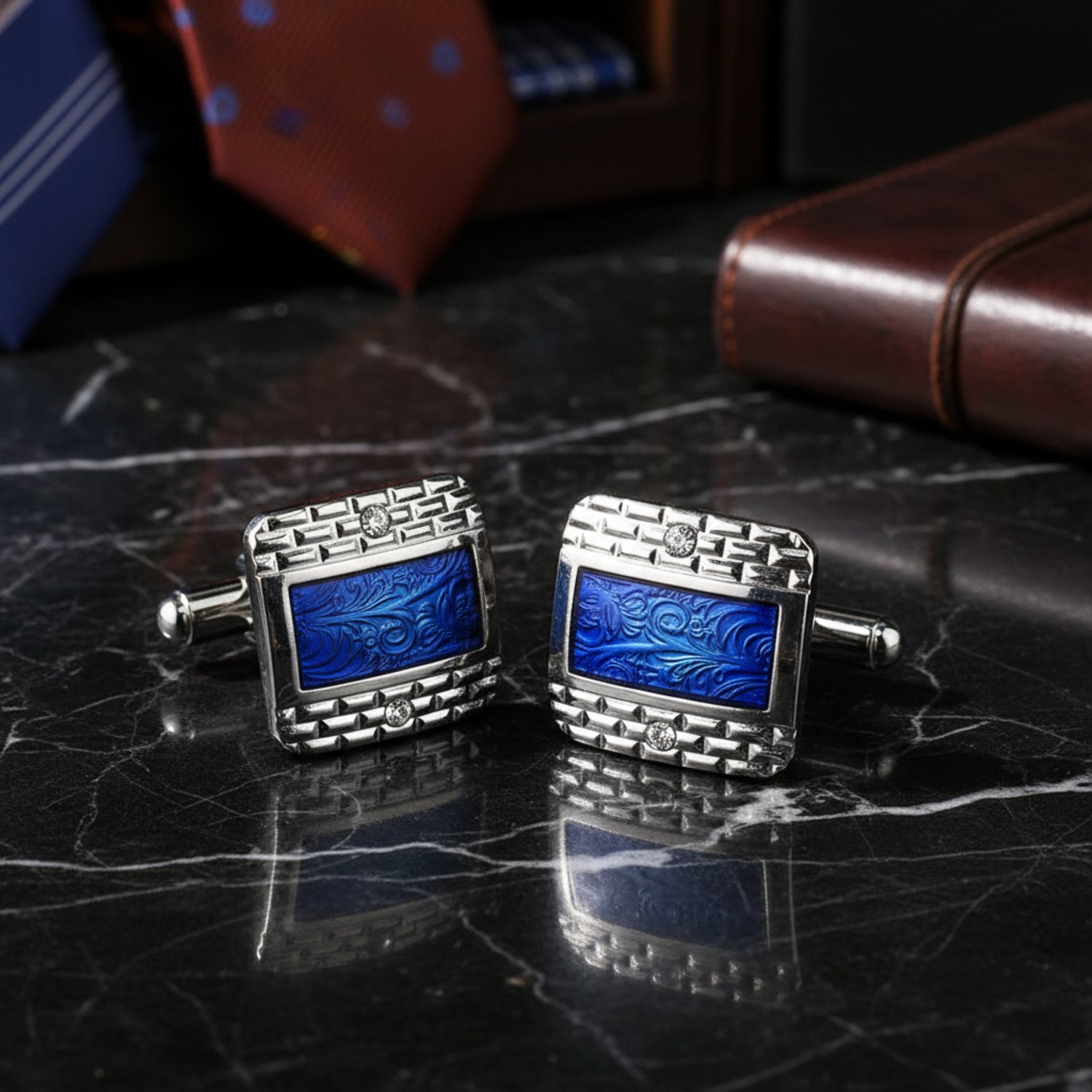 View 3: A chrome and blue colored rectangle shaped with checkerboard and waves detail pair of cuff-links