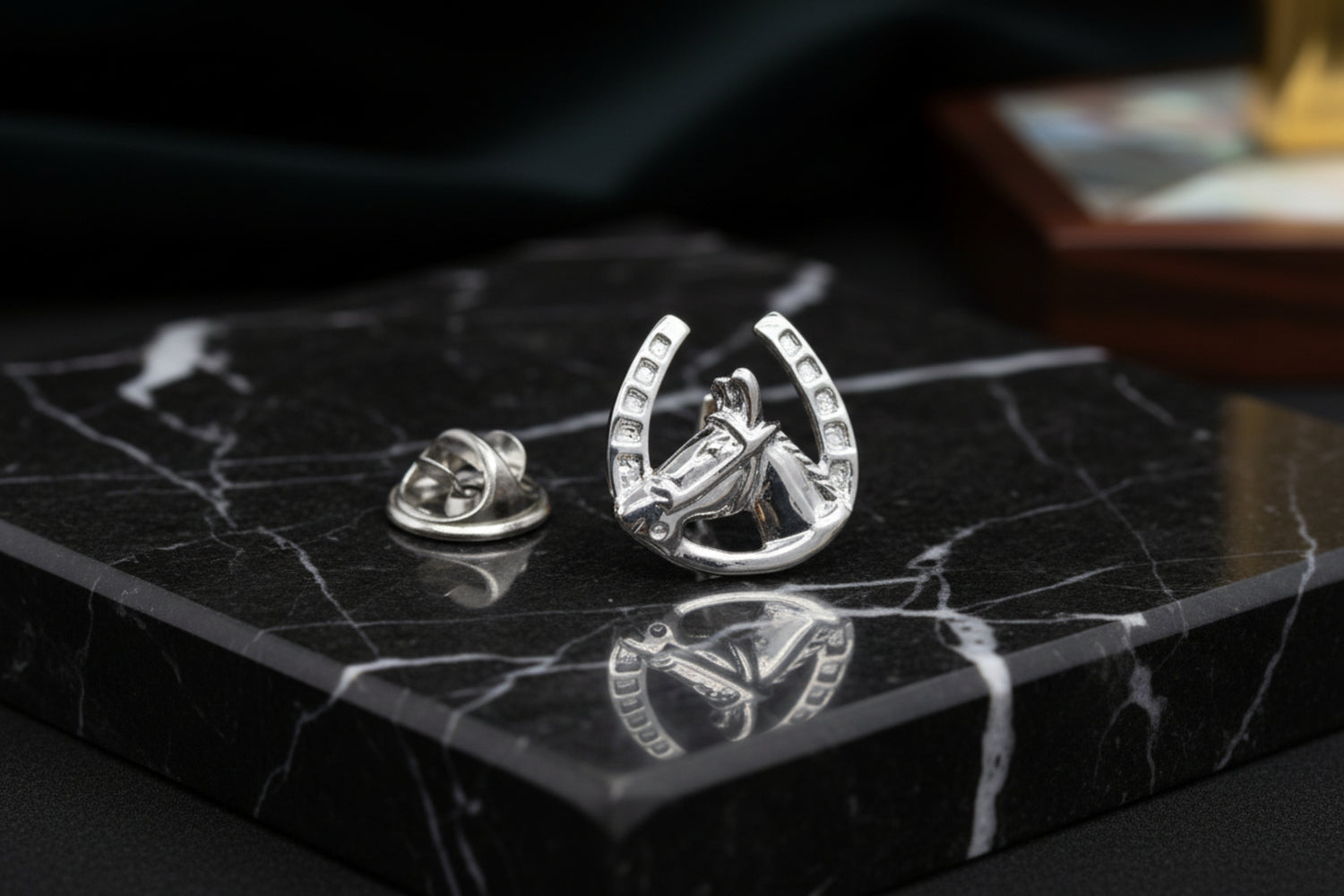 A Chrome Colored Horseshoe and Horse Head Lapel Pin