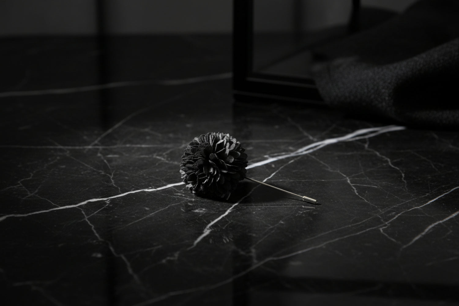 A Solid Charcoal Colored Thin Petal Lapel Flower Burst