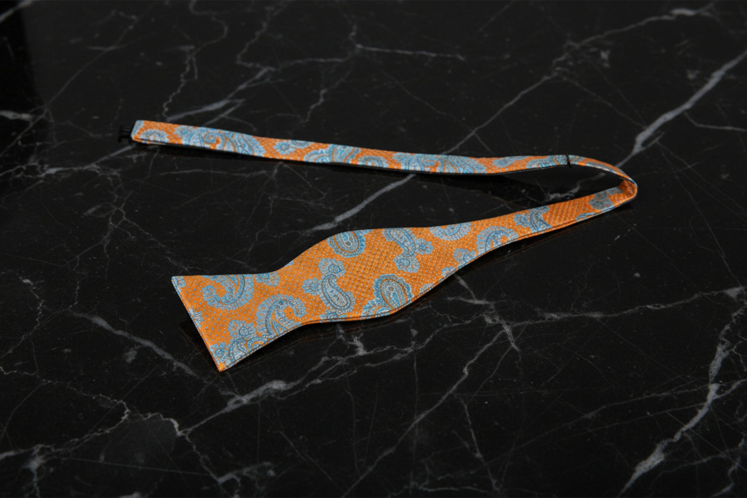 A Light Orange and Ice Blue Paisley Pattern Self Tie Bow Tie Untied