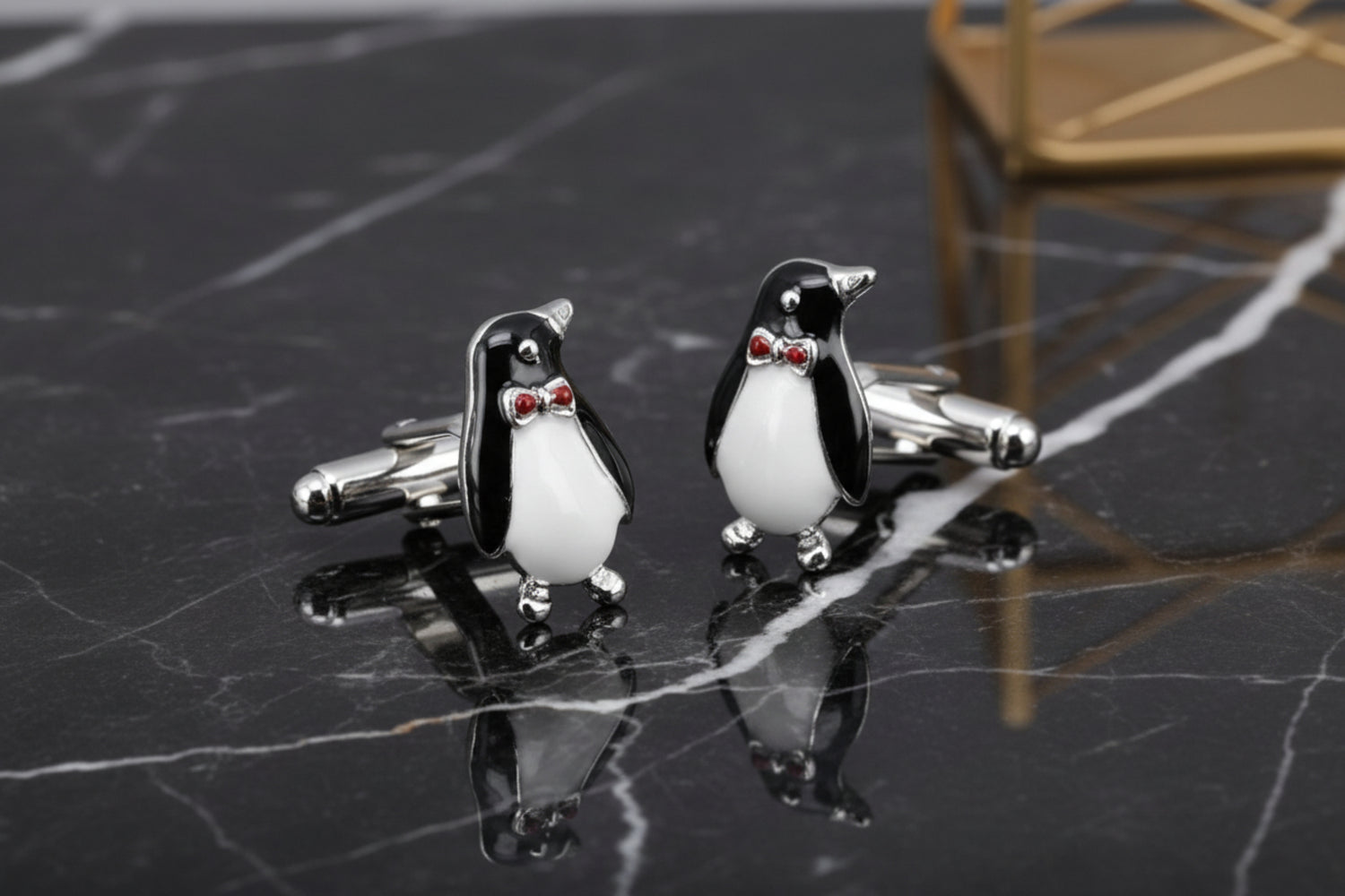 A black, white, red color penguin design pair of cuff-links