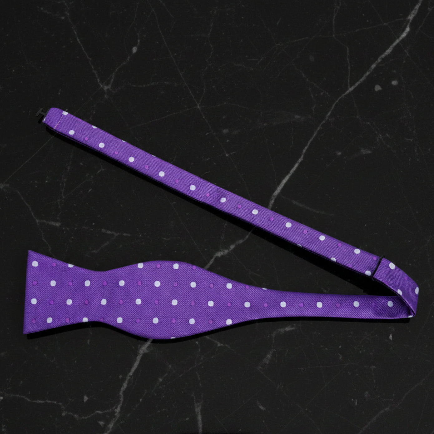 A Purple, White Polka Dot Pattern Self Tie Bow Tie Untied