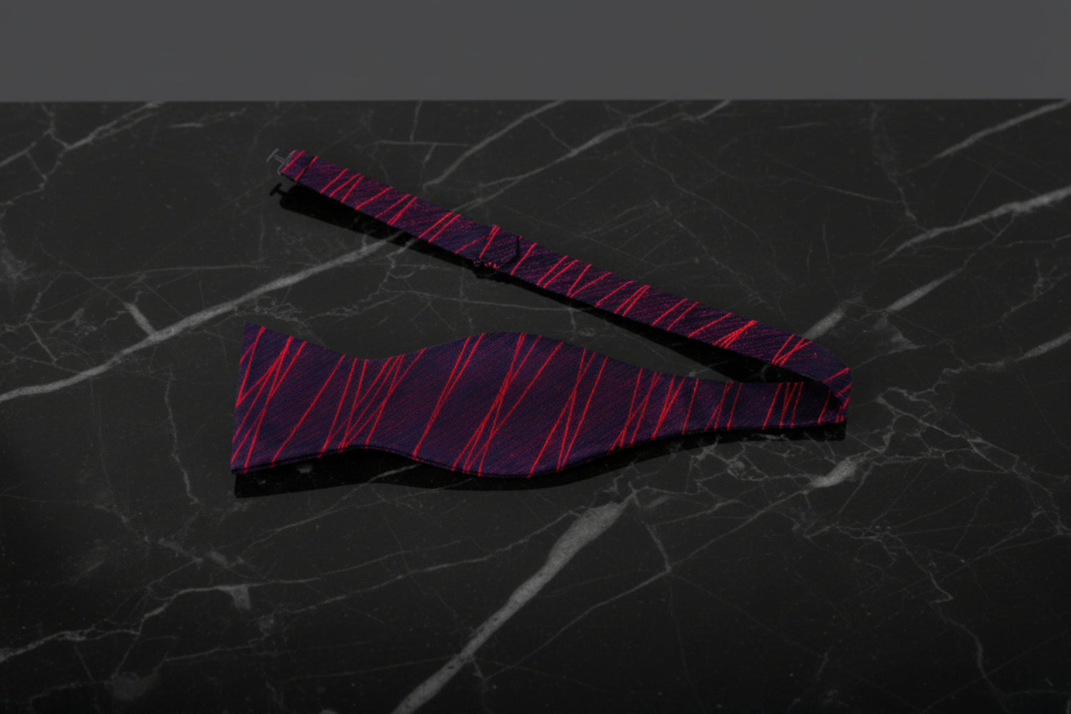 A Red, Black 3D Intersecting Abstract Lines Pattern Self Tie Bow Tie Untied