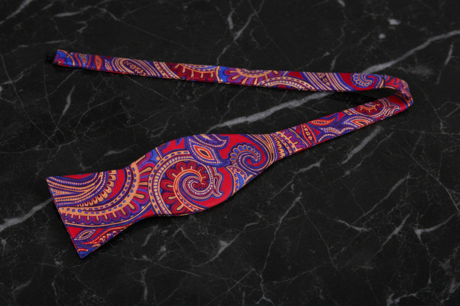 A Red, Blue Paisley Pattern Self Tie Bow Tie Untied
