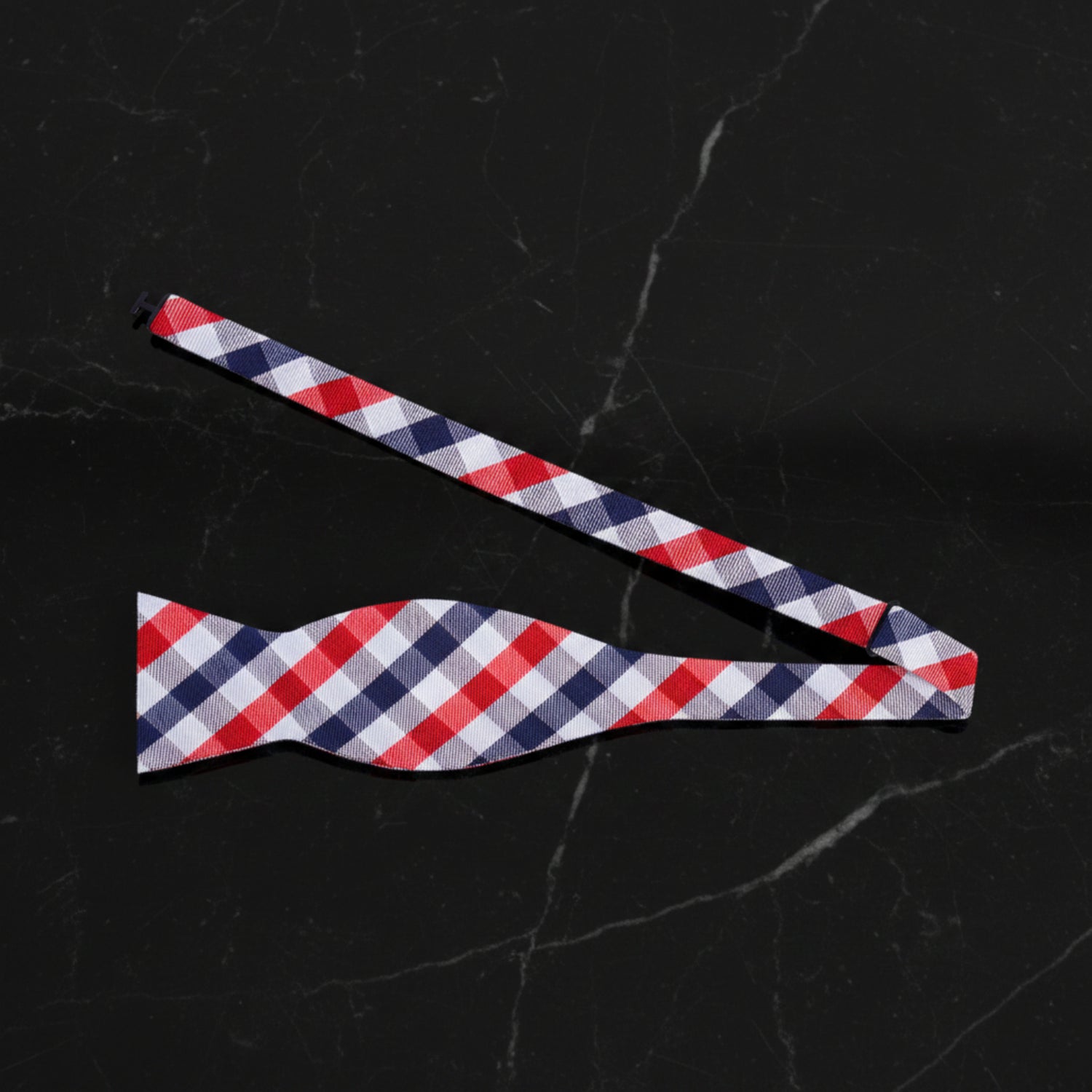 A Red, White, Blue Small Geometric Checker Pattern Self Tie Bow Tie untied