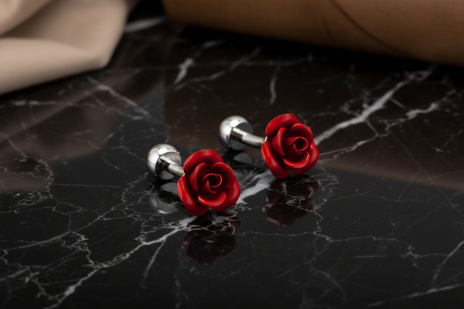 A small red colored rose shaped cuff-links||Red