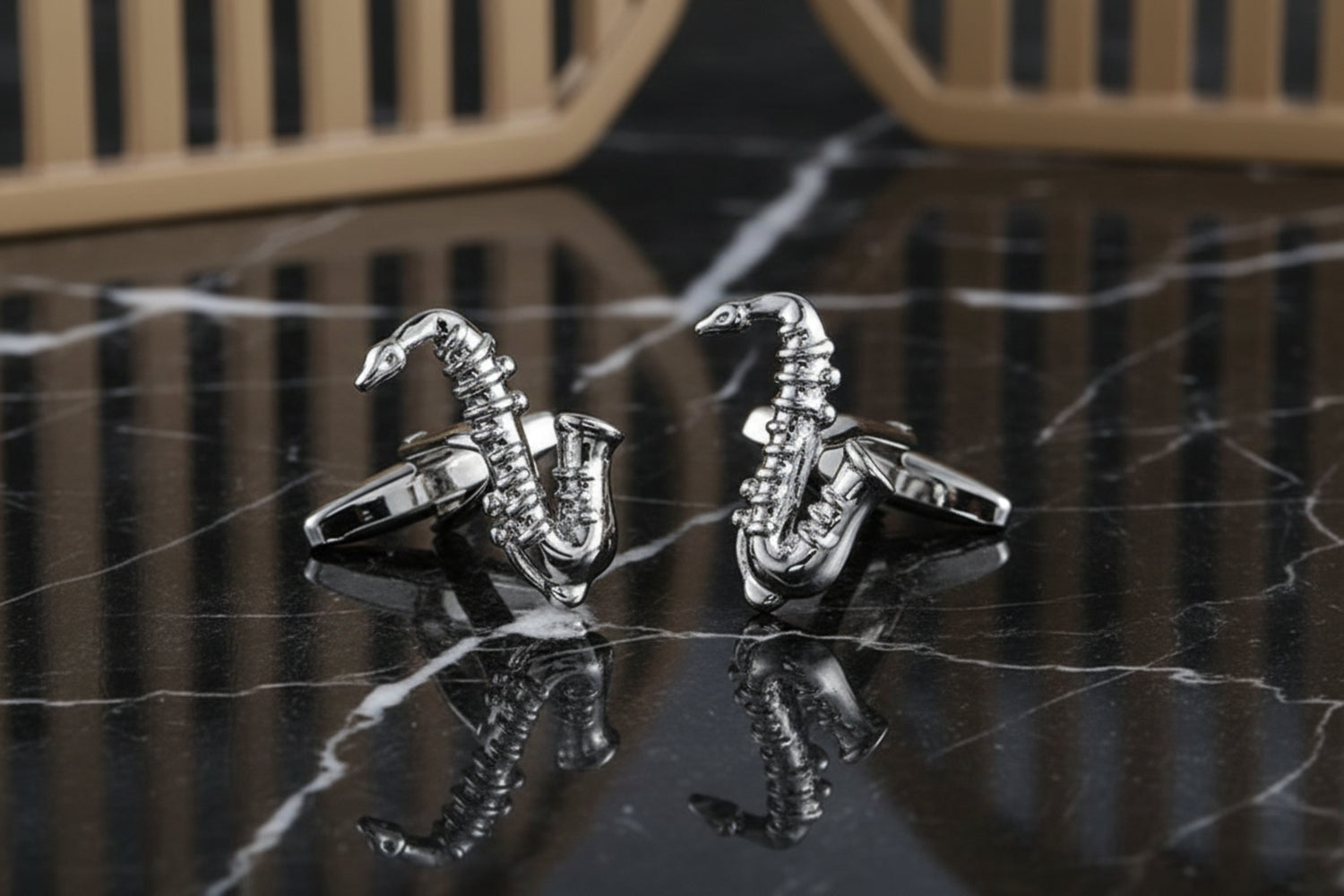 A Chrome Colored Saxophone Shaped Cuff-links.