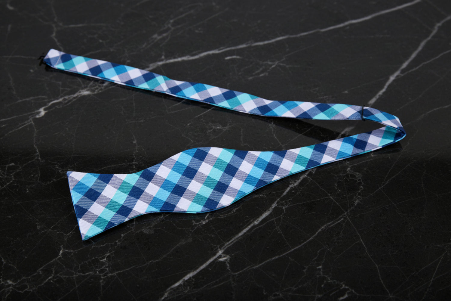 A Light Blue, White Geometric Check Pattern Silk Self Tie Bow Tie Untied
