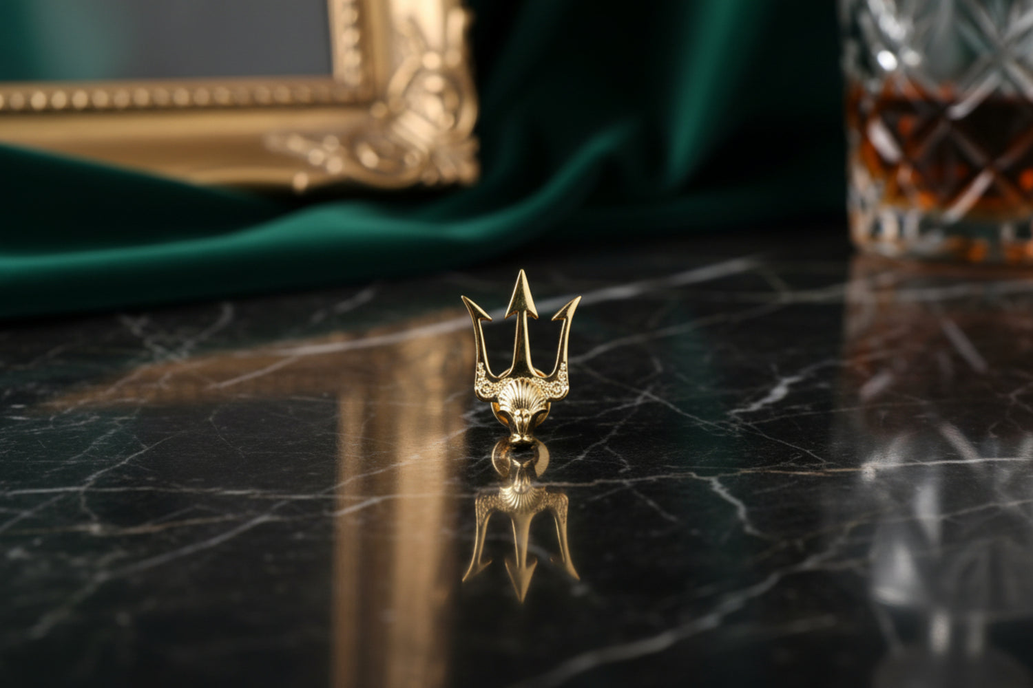 A Small Gold Colored Trident Shaped Lapel Pin
