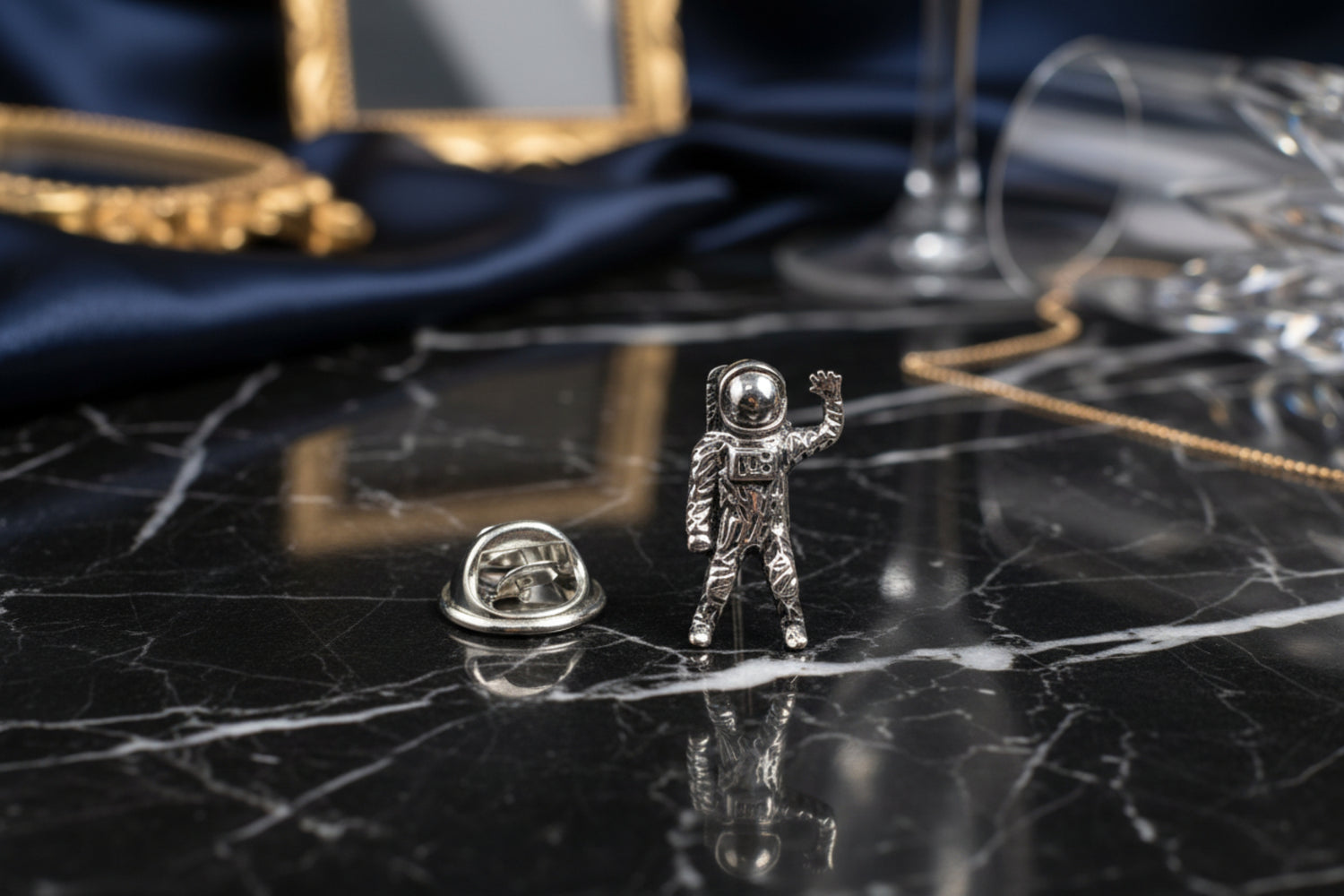 A chrome colored astronaut shaped lapel pin