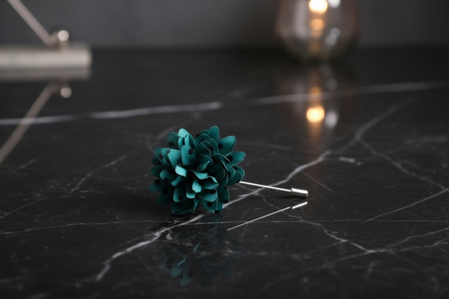 teal with black dot lapel flower