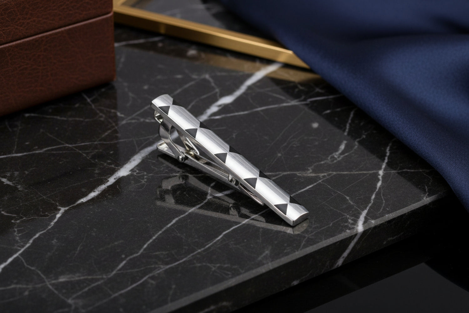 A Chrome and Black X Design Tie Bar