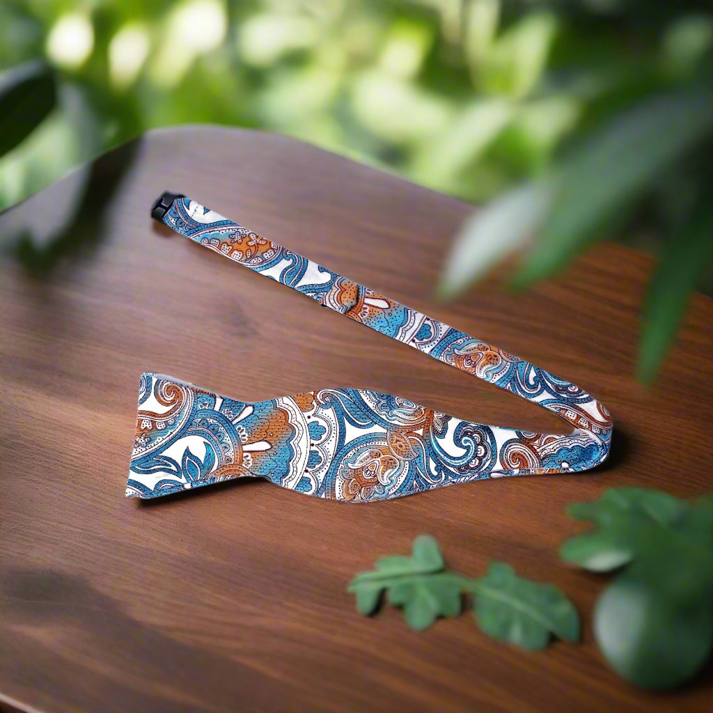 A White, Light Blue, Orange Paisley Pattern Self Tie Bow Tie Untied