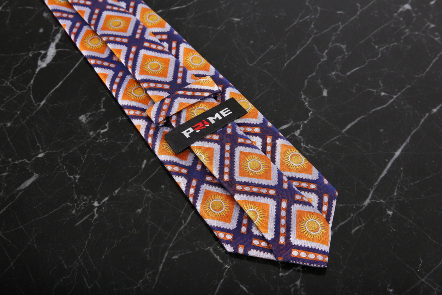 Logo View: A Dark Blue, Orange Sunburst Design Zipper Necktie With Logo On Back Of Tie Keep Loop