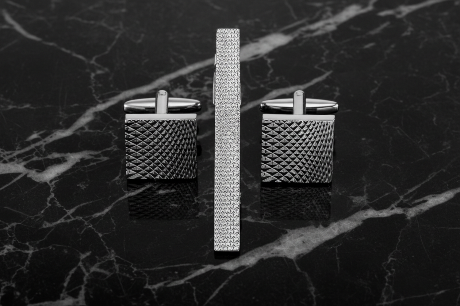 A charcoal textured tie bar and cuff-links||Charcoal