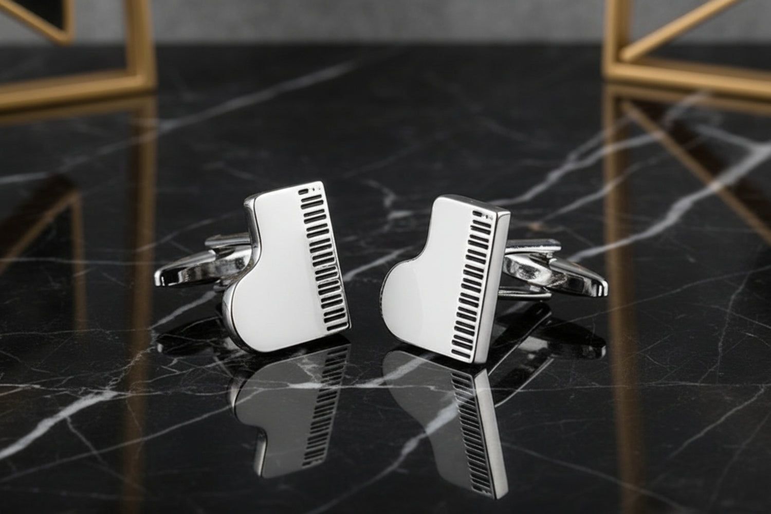 A Chrome and Black Piano Shape Cuff-links Set.