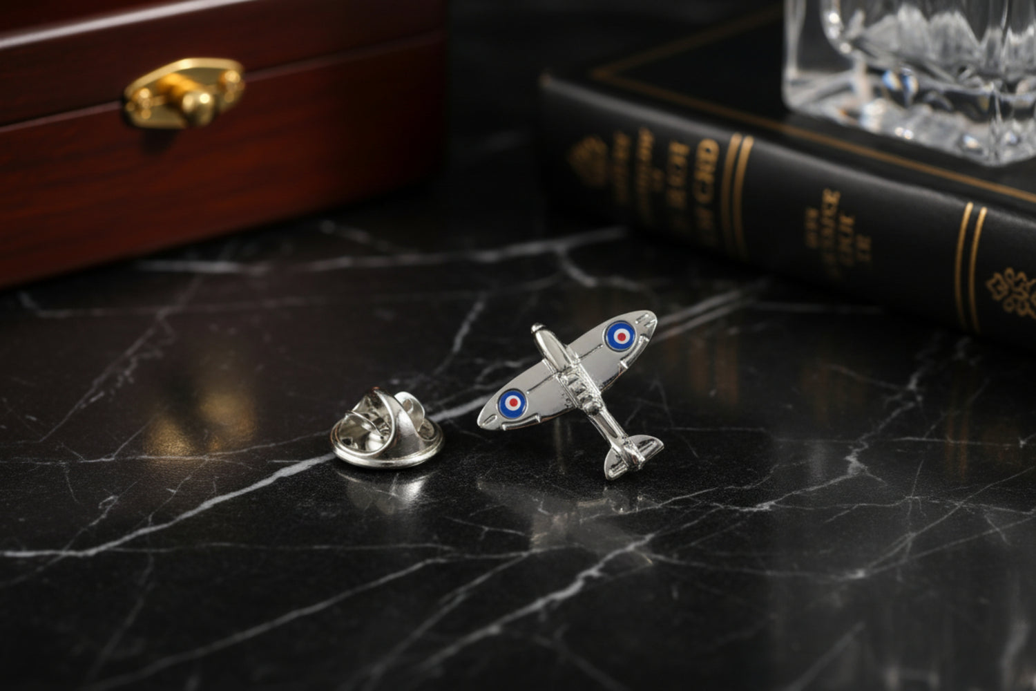 A chrome colored airplane shaped lapel pin