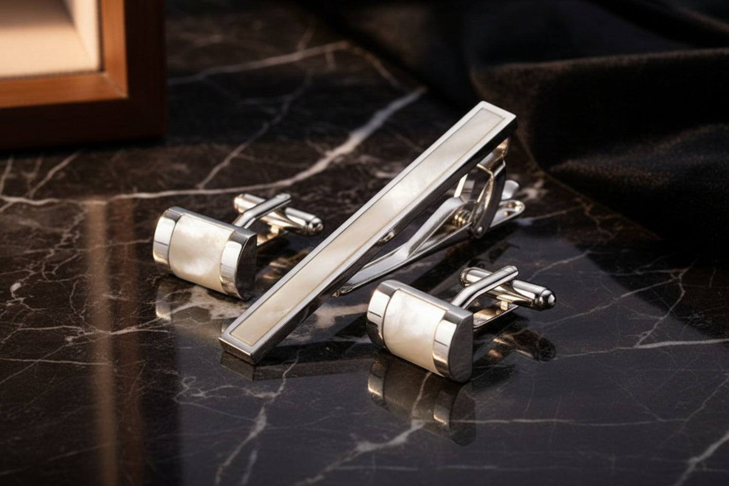 A Chrome and Pearl Colored Sphere Shaped Tie Bar and Cuff-links Set