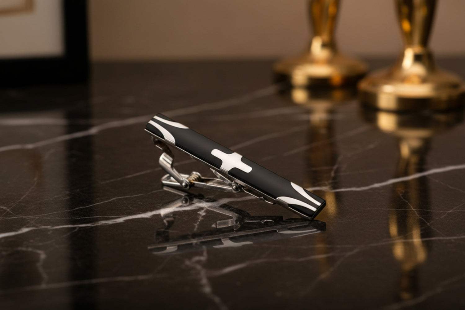 A Black, Chrome Colored X Shaped Tie Bar 